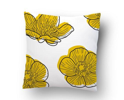 White pillow with yellow floral print pattern