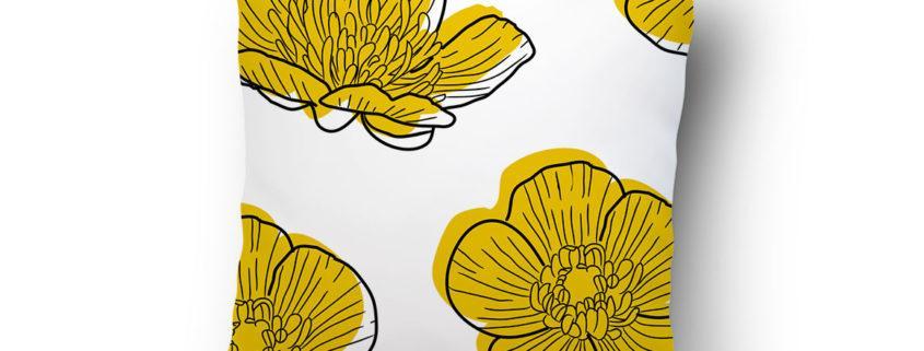 White pillow with yellow floral print pattern
