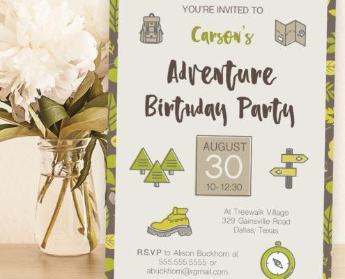 Sample printed birthday party invitation sitting on table next to flowers