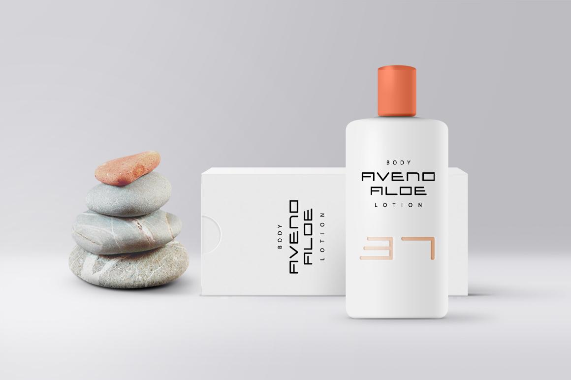 Bottle of body lotion next to stacked pebbles