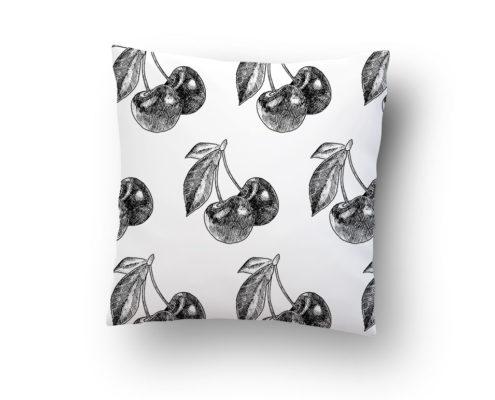 White pillow with black cherry print pattern