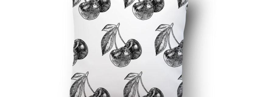 White pillow with black cherry print pattern