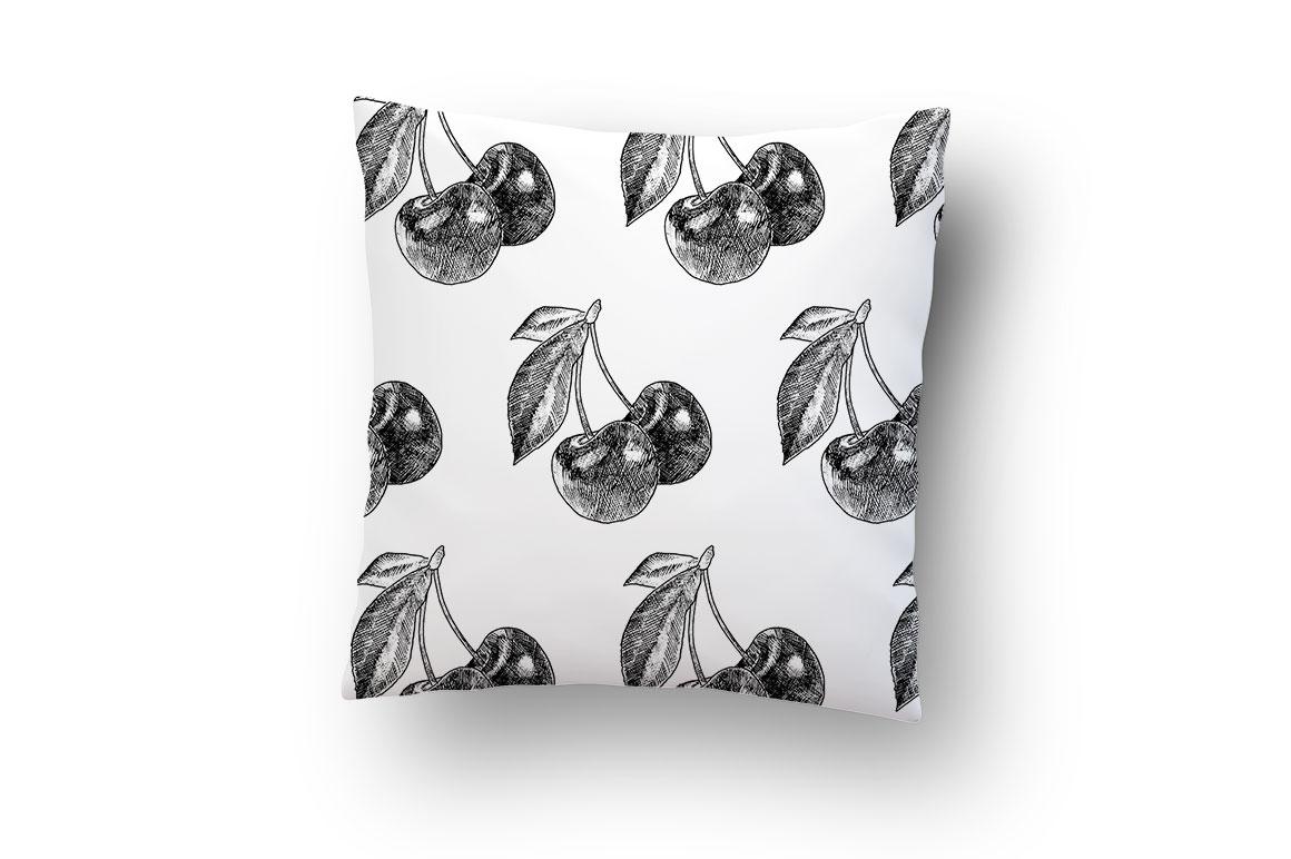 White pillow with black cherry print pattern