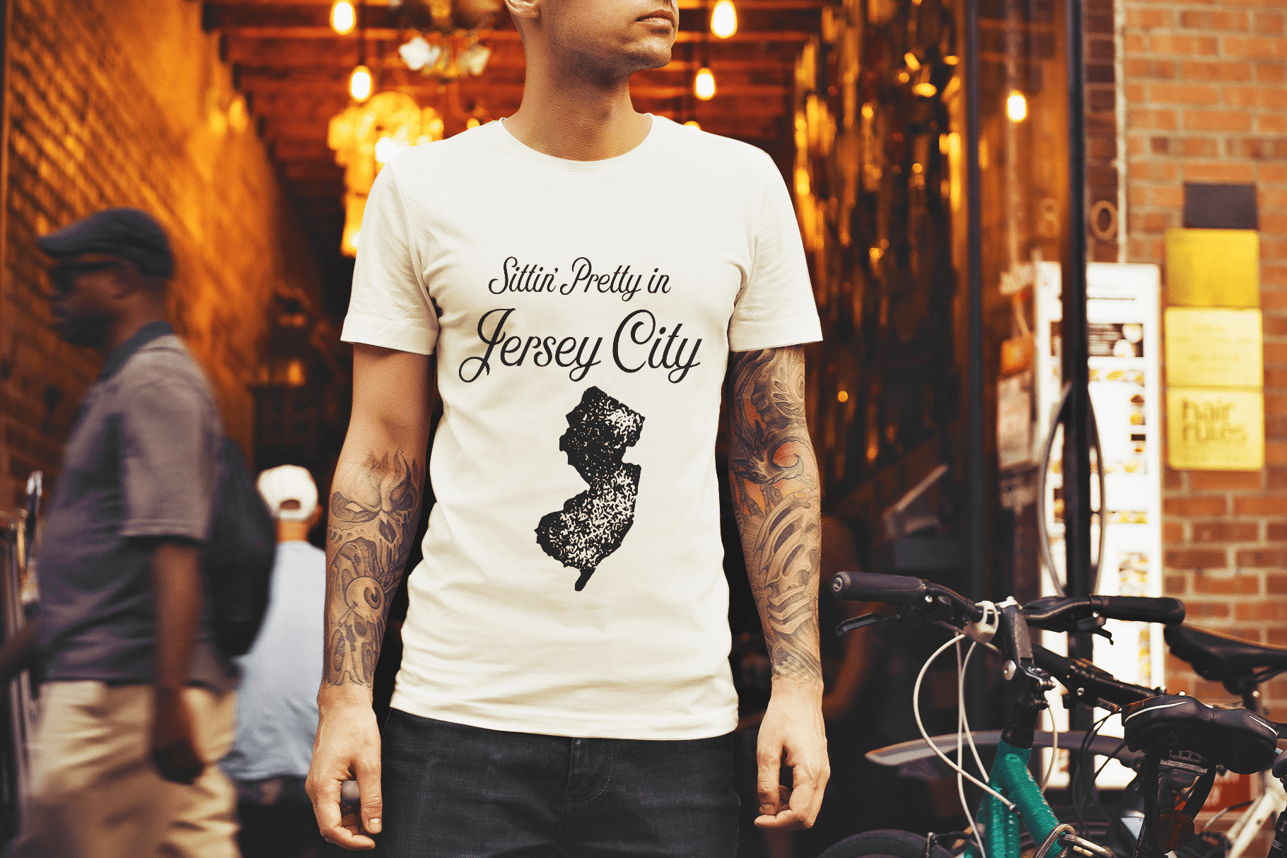 Tattooed man wearing Jersey City t-shirt